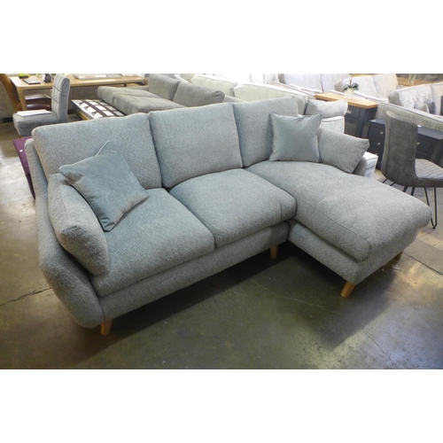 1508 - A light grey fabric three seater sofa/chaise