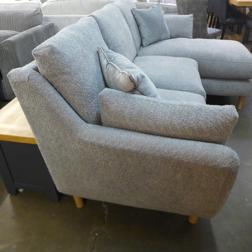 1508 - A light grey fabric three seater sofa/chaise