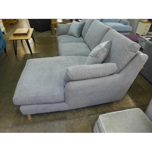 1508 - A light grey fabric three seater sofa/chaise