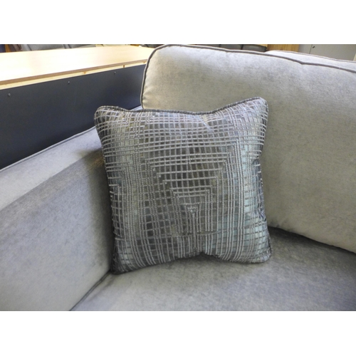 1384 - A Casey silver velvet three seater sofa