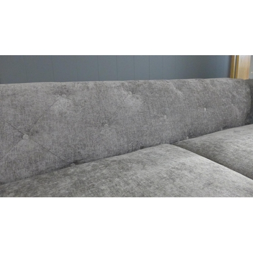 1532 - A grey button back fabric three seater sofa