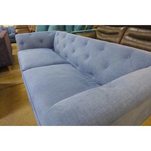 1555 - An Cadet blue fabric button back three seater sofa