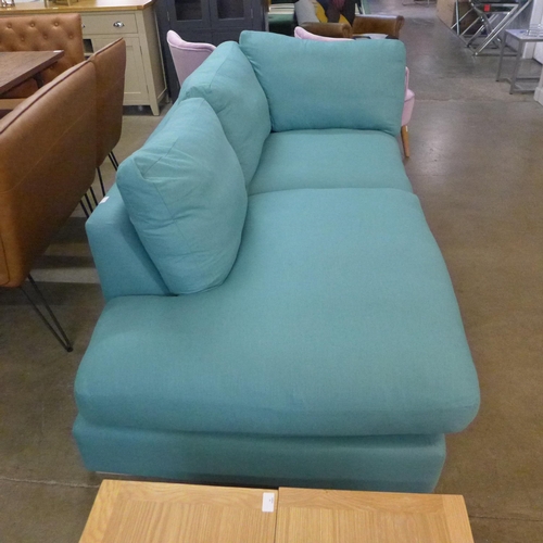 1677 - A turquoise upholstered corner sofa/chaise, slight damage to back