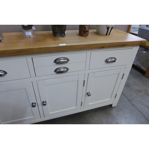 1355 - A Hampshire cream painted and oak large three drawer sideboard *This lot is subject to VAT