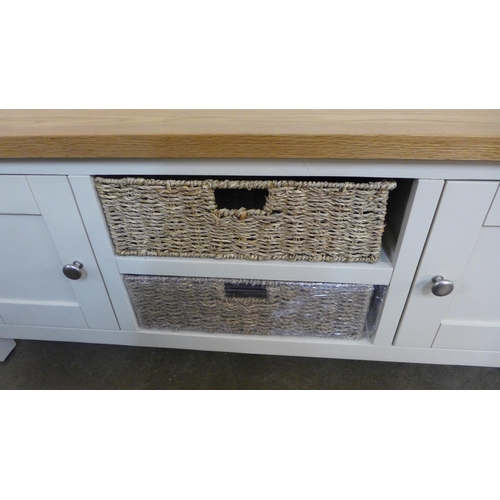 1379 - A Salisbury cream painted and oak large TV unit with baskets *This lot is subject to VAT