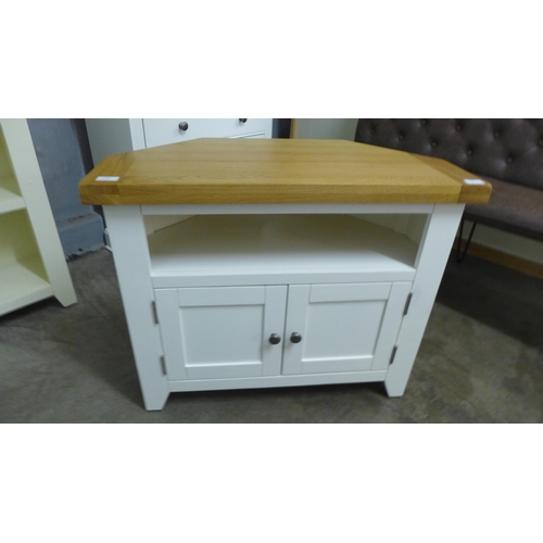 1408 - A Hampshire white painted and oak corner TV unit*This lot is subject to VAT