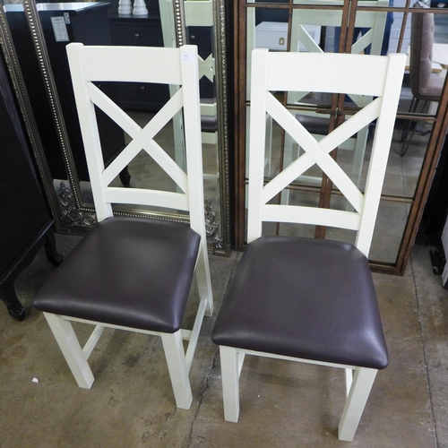 1435 - A pair of painted cross back dining chairs * This lot is subject to VAT