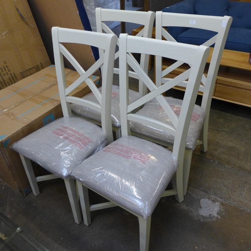 1574 - A set of four cross back dining chairs *This lot is subject to VAT