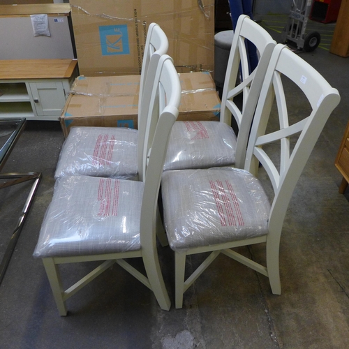 1574 - A set of four cross back dining chairs *This lot is subject to VAT