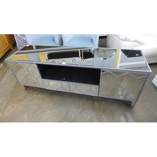 1600 - A mirrored TV unit *This lot is subject to VAT