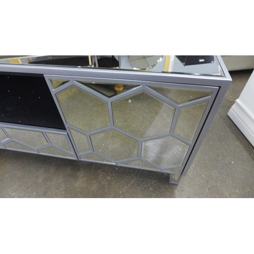 1600 - A mirrored TV unit *This lot is subject to VAT