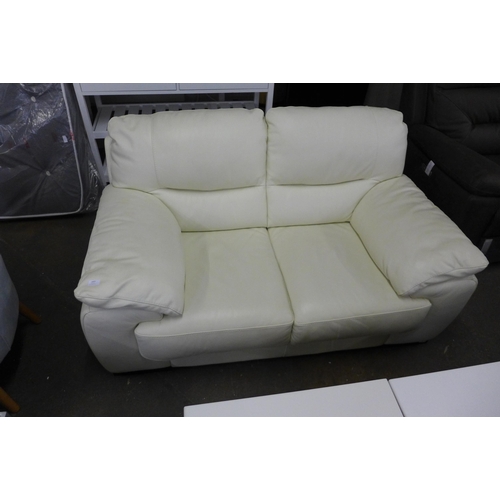 1603 - A cream Italian leather two seater sofa