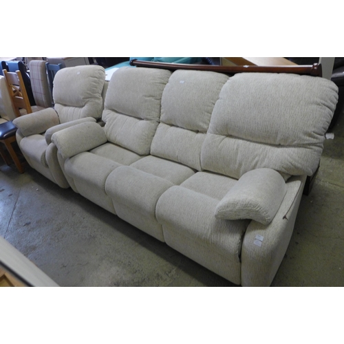 1663 - A light grey fabric three seater sofa and armchair