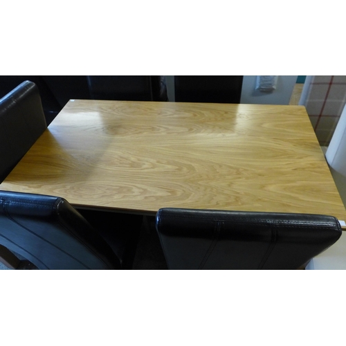 1665 - A 80 x 140 dining table and four chairs