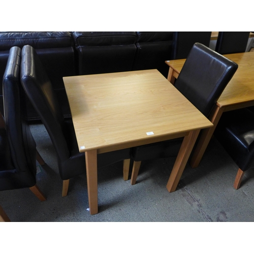 1666 - A square table and two leather effect dining chairs