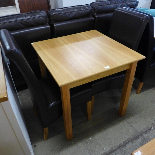 1689 - A 90 x 90 dining table and two chairs