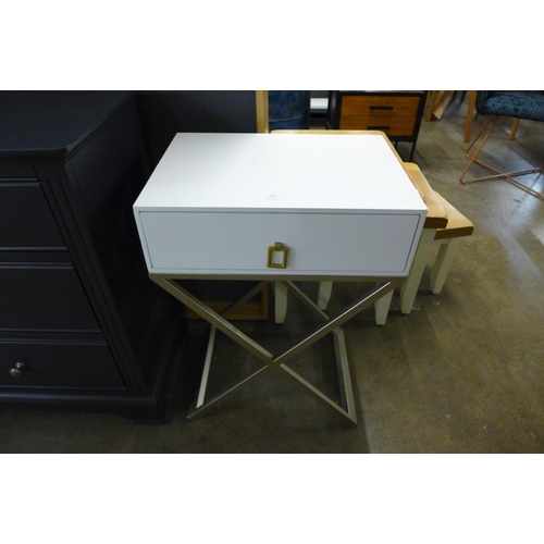 1439 - A white bedside table with cross legs ( chipped paint )