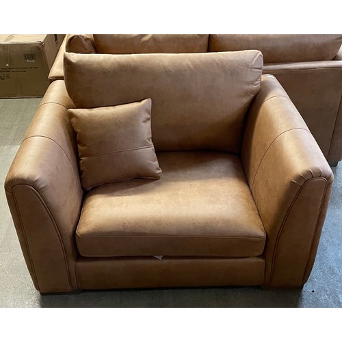 1306 - An Austin milan tan faux leather snuggle chair RRP £599.99