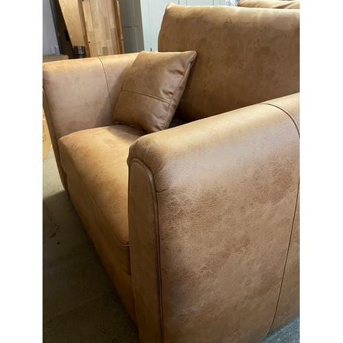 1306 - An Austin milan tan faux leather snuggle chair RRP £599.99