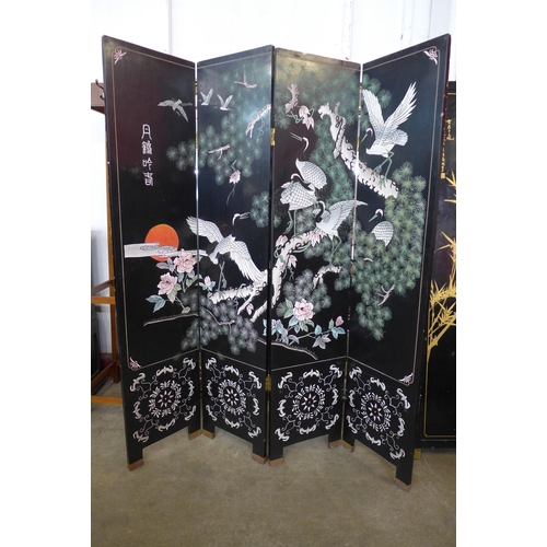 124 - A Japanese black lacquered folding four panel dressing screen, a/f