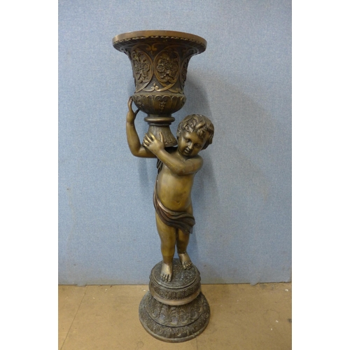 418 - A large French style bronze figural cherub urn, 125cms h