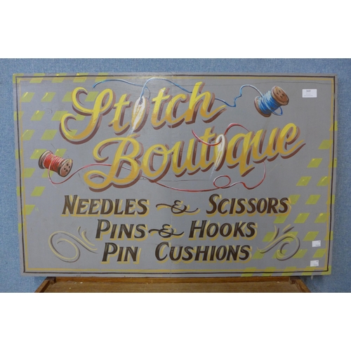 427 - A painted wooden Stitch Boutique advertising sign