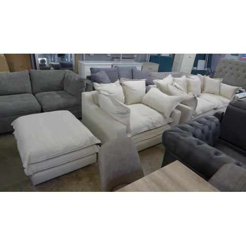 1528 - A designer three seater sofa, armchair and footstool, in natural brushed cotton (has minor handling ... 