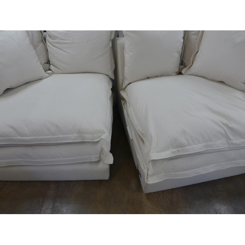 1528 - A designer three seater sofa, armchair and footstool, in natural brushed cotton (has minor handling ... 