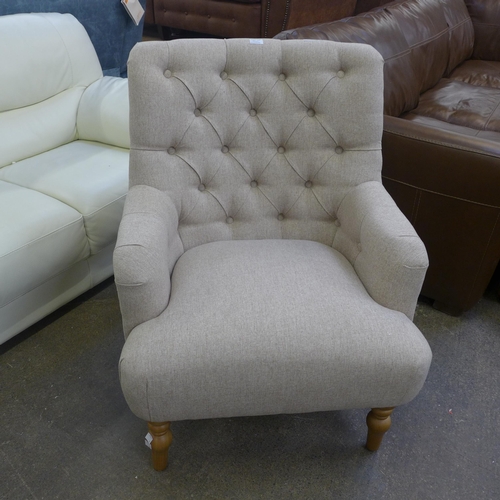 1529 - An Atlanta beige fabric button back armchair - Boxed