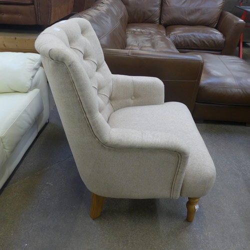 1529 - An Atlanta beige fabric button back armchair - Boxed