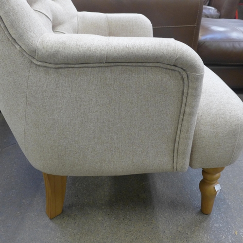 1529 - An Atlanta beige fabric button back armchair - Boxed