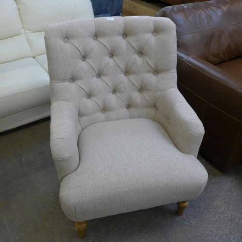 1530 - An Atlanta beige fabric button back armchair Display