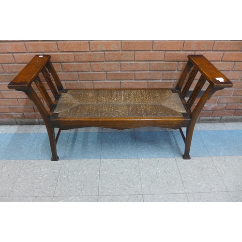 1 - An Arts and Crafts oak and rush seated window seat