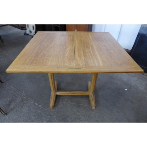 127 - A Cotswold style oak fold over table