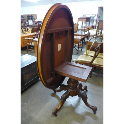 30 - A Victorian figured walnut oval tilt-top centre table