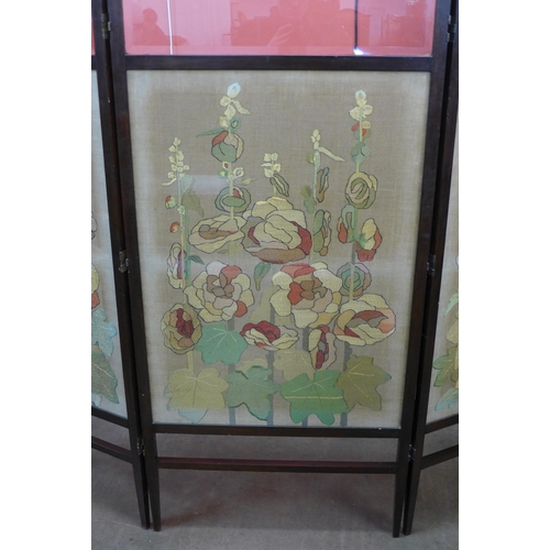 32 - An Arts and Crafts mahogany and embroidered three panel folding dressing screen