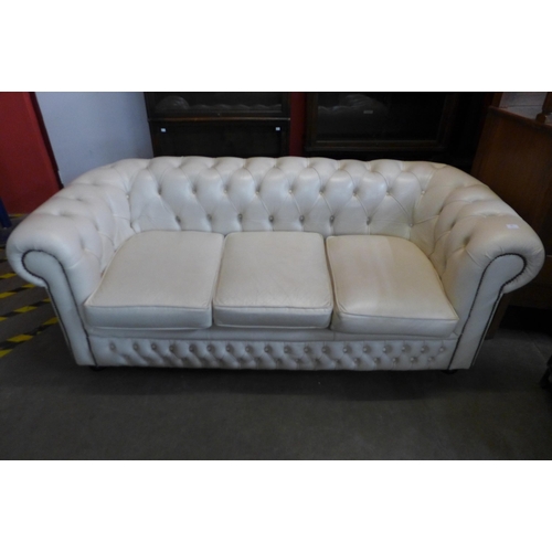 38 - A cream leather Chesterfield settee and matching club chair