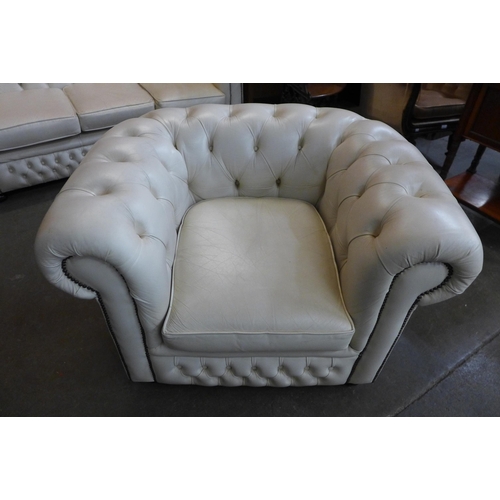 38 - A cream leather Chesterfield settee and matching club chair