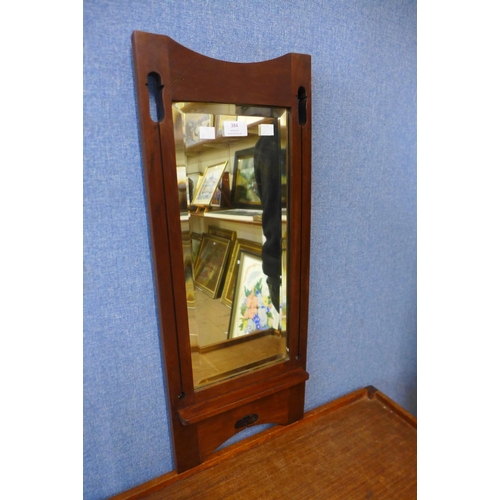 384 - An Arts and Crafts walnut framed hall mirror