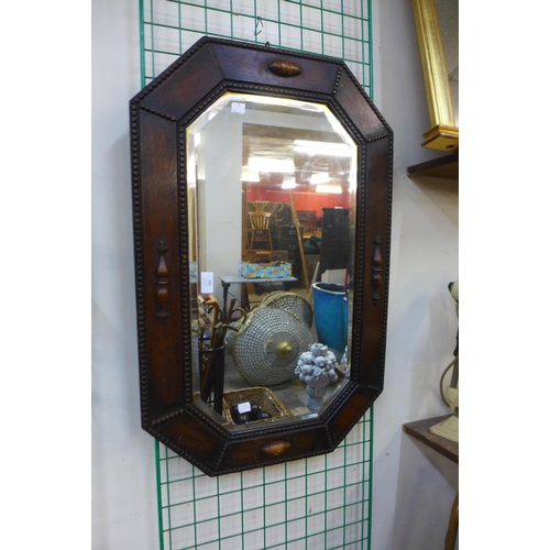 386 - An early 20th Century oak framed octagonal mirror