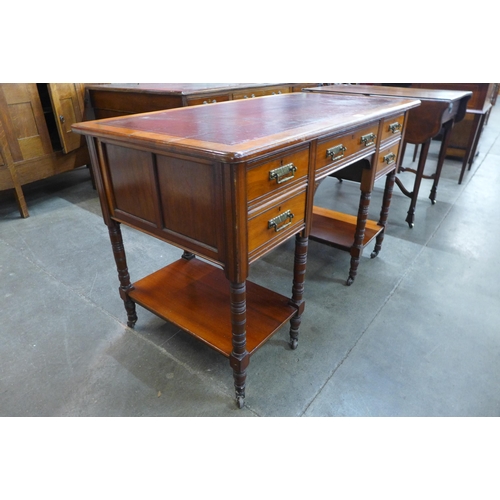 42 - A Victorian walnut and red leather topped five drawer writing table