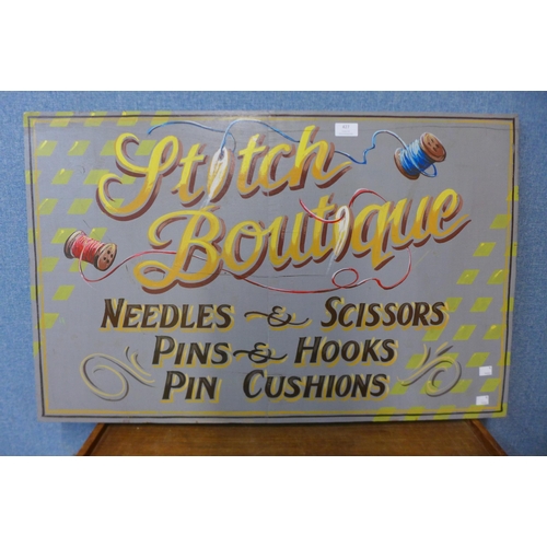 427 - A painted wooden Stitch Boutique advertising sign