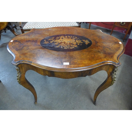 51 - A Victorian marquetry inlaid walnut and gilt metal mounted serpentine centre table