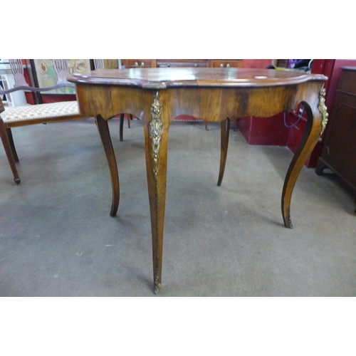 51 - A Victorian marquetry inlaid walnut and gilt metal mounted serpentine centre table