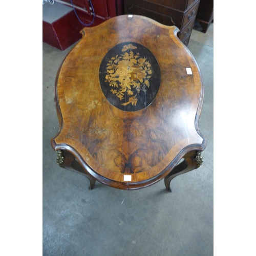 51 - A Victorian marquetry inlaid walnut and gilt metal mounted serpentine centre table