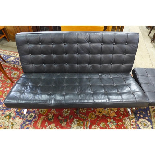 98 - A Barcelona style chrome and black leather sofa and footstool