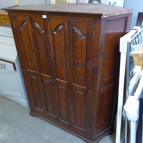 1754 - A Gothic style floor standing corner cupboard, with bi-fold doors