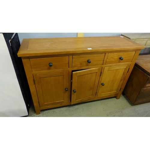 1772 - An oak three door sideboard