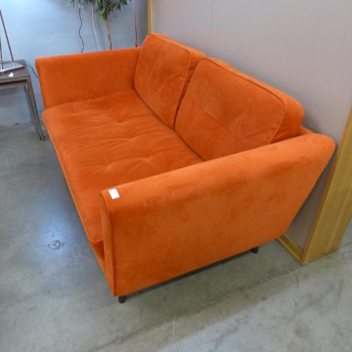 1302 - A designer orange velvet upholstered two seater sofa - Ex display