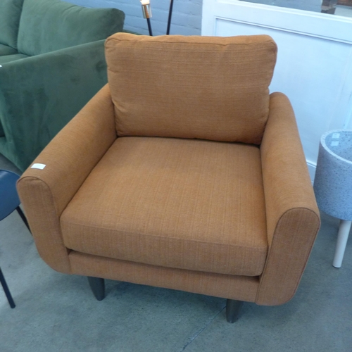 1334 - A designer burnt orange upholstered armchair